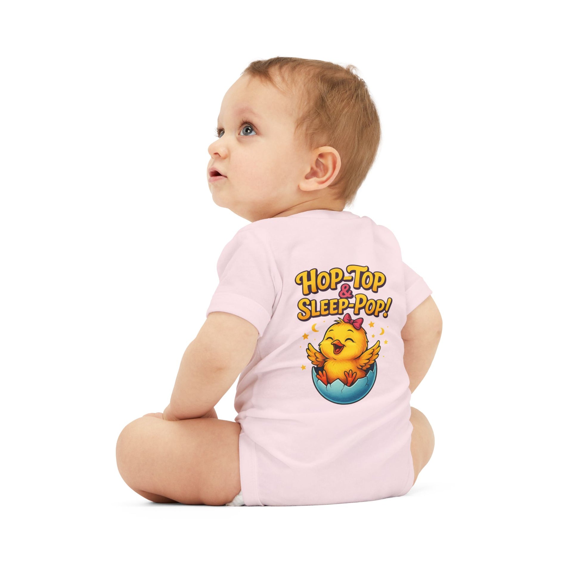 Baby wearing a pink onesie with a cartoon character and text on a white background