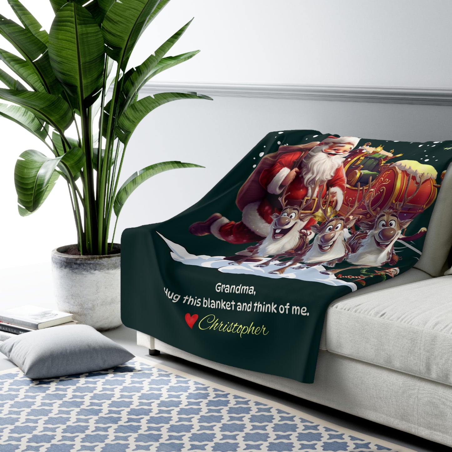 Blanket with Santa Claus and reindeer design on a couch, featuring text.